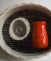 Holly Hanessian, My Taste Your Bones. 2010. Sculptural book edition, 1 of 4. Porcelain containers and book covers,  laser-engraved acrylic lid, test tubes, nails, hair and fishing line. 9.5 x 7 x 4.5 in. 